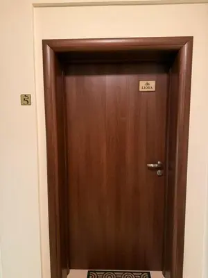 a wooden door with a sign on it at Апартамент Liora in Smolyan