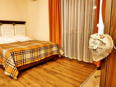 a bedroom with a bed and a window at Приказното място - The Fairytale Place in Smolyan