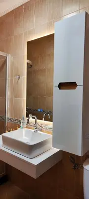 a bathroom with a white sink and a mirror at Приказното място - The Fairytale Place in Smolyan