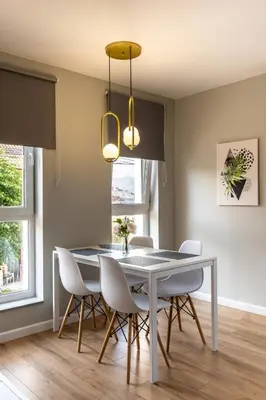 a dining room with a table and chairs at TheHouse - Apartment Kamenitza in Velingrad