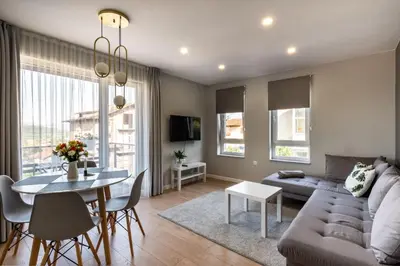 a living room with a couch and a table at TheHouse - Apartment Kamenitza in Velingrad