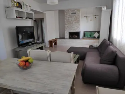 a living room with a table with a bowl of fruit on it at Апартамент “МИЛА” in Troyan