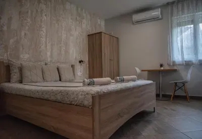 a bedroom with a large bed in a room at Къща за гости Фолис in Kyustendil