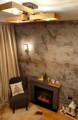 a living room with a chair and a fireplace at Pinewood ANG Apartment, Semiramida Borovets Hills in Borovets