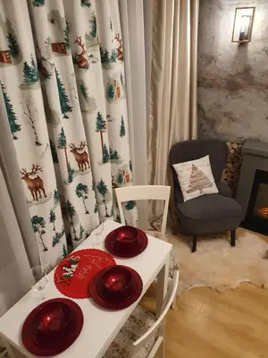 a living room with a table with red plates on it at Pinewood ANG Apartment, Semiramida Borovets Hills in Borovets