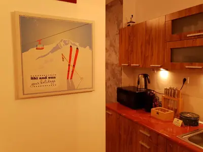 a kitchen with a picture hanging on the wall at Pinewood ANG Apartment, Semiramida Borovets Hills in Borovets