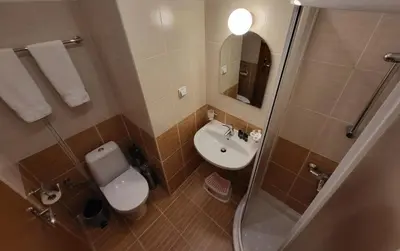 a bathroom with a sink and a toilet and a mirror at Pinewood ANG Apartment, Semiramida Borovets Hills in Borovets
