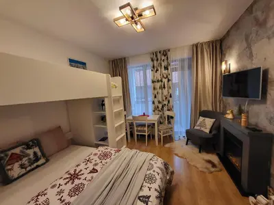 a bedroom with a bunk bed and a living room at Pinewood ANG Apartment, Semiramida Borovets Hills in Borovets