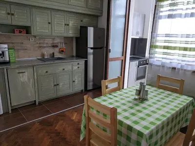 a kitchen with a table with a green and white checkered table cloth at Midtown Place Apartment DORIS 1 with garage in Plovdiv