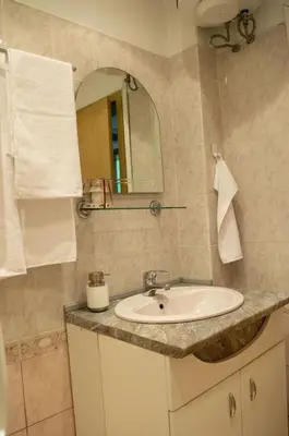 a bathroom with a sink and a mirror at Midtown Place Apartment DORIS 1 with garage in Plovdiv