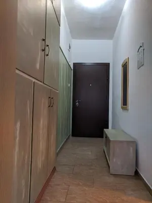 a hallway with a black door and a room with a bench at Midtown Place Apartment DORIS 1 with garage in Plovdiv