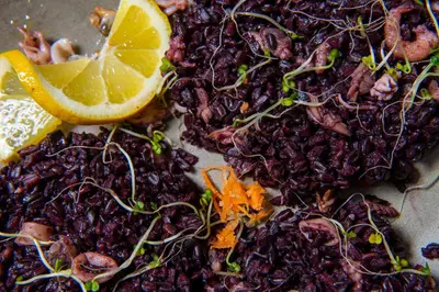 a pile of dried fruit with a slice of lemon at Хотел Дива in Blagoevgrad