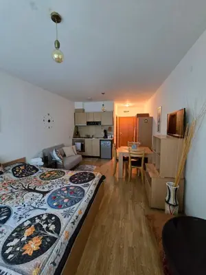 a room with a bed and a living room and a kitchen at Aspen Valley in Razlog