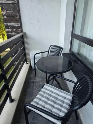 two chairs and a table and a table and chairs on a balcony at Aspen Valley in Razlog
