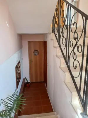 a hallway with a staircase with a wooden door at Guest rooms Bansko in Bansko