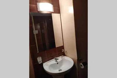 a bathroom with a sink and a mirror at Bansko Royal Towers - Studio 945 in Bansko
