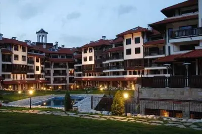 a large apartment building with a swimming pool at night at Bansko Royal Towers - Studio 945 in Bansko