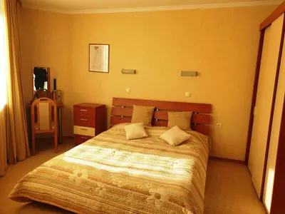 a bedroom with a large bed with two pillows at апартамент Манастира 1 in Pamporovo