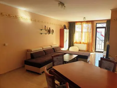 a living room with a couch and a table at апартамент Манастира 1 in Pamporovo