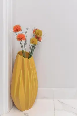 a yellow vase with flowers in it on a wall at Stylish Residential Flat - with Parking & Balcony by Flat Mаnager in Sofia