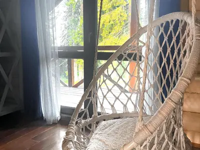 a swing in front of a window in a room at Власовъ in Pamporovo