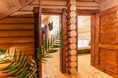 a hallway of a wooden cabin with a door at Власовъ in Pamporovo