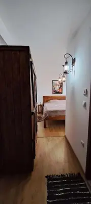 a room with a bedroom with a bed and a door at апартамент Гигови in Bansko