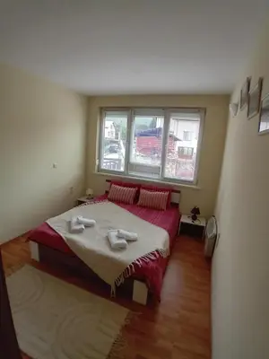 a bedroom with a bed with two towels on it at Cosy Apartment with terrace Eagle Rock in Beli Iskar