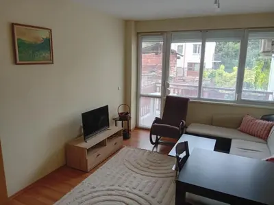 a living room with a couch and a tv at Cosy Apartment with terrace Eagle Rock in Beli Iskar