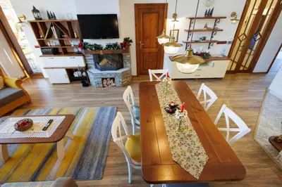 a living room with a wooden table with a napkin on it at Mountain villa Jordan- with JACUZZI in Razlog