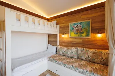a childs bedroom with a bunk bed and wooden walls at Mountain villa Jordan- with JACUZZI in Razlog