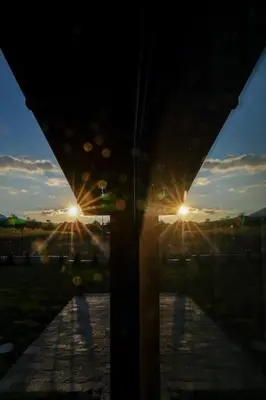 a view of the sunset from a window with two lights at Mountain villa Jordan- with JACUZZI in Razlog