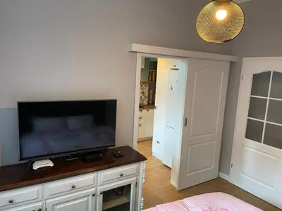 a living room with a flat screen tv sitting on a cabinet at Solunska Stylish Apartment in Sofia