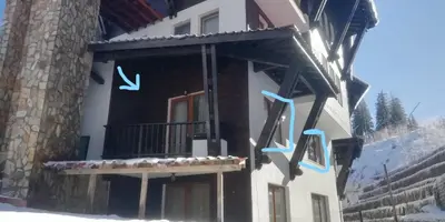 a building with a sign on the side of it at Grand Monastery Violet Apartment With One Bedroom And A Terrace in Pamporovo
