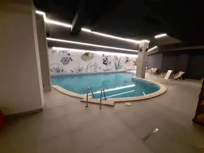 a swimming pool in the middle of a room at Flora Apartment 612A in Borovets