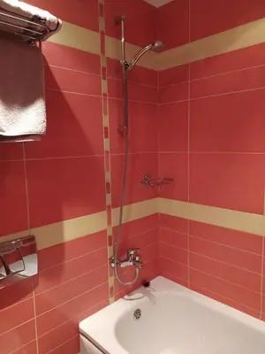 a red bathroom with a shower and a sink at BOROVETS Royal Plaza - A405 in Borovets