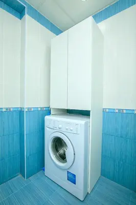 a washing machine in a bathroom with blue tiles at Dream Park Apartment in Sandanski