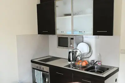 a small kitchen with a sink and a microwave at BOROVETS Royal Plaza - A409 in Borovets
