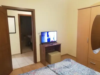 a bedroom with a tv on a stand with a bed at BOROVETS Royal Plaza - A409 in Borovets