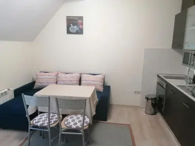 a small kitchen with a table and chairs in a room at BOROVETS Royal Plaza - A409 in Borovets
