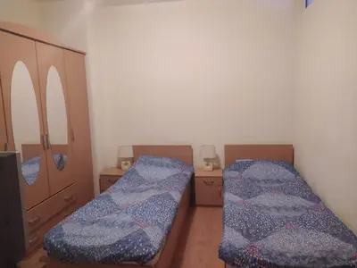 a room with two beds and a cabinet at BOROVETS Royal Plaza - A409 in Borovets