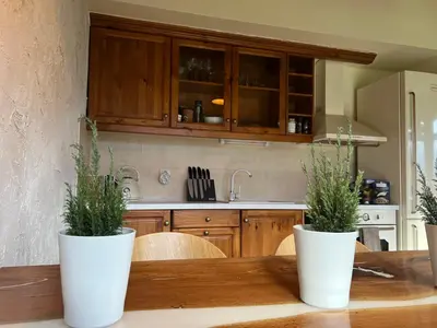 two white vases on a wooden table in a kitchen at Katarino Spa Chalet in Razlog