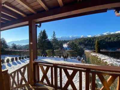 a view from the balcony of a resort with snow covered mountains at Katarino Spa Chalet in Razlog
