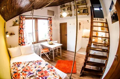 a small room with a bed and a table at Off Vitosha Blvd Designer Studio in Sofia
