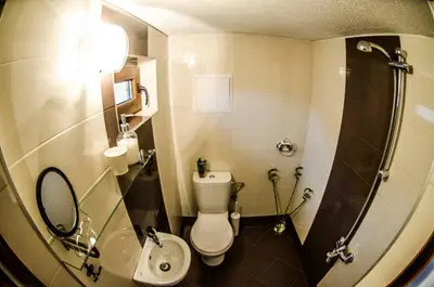 a bathroom with a toilet and a sink and a shower at Off Vitosha Blvd Designer Studio in Sofia