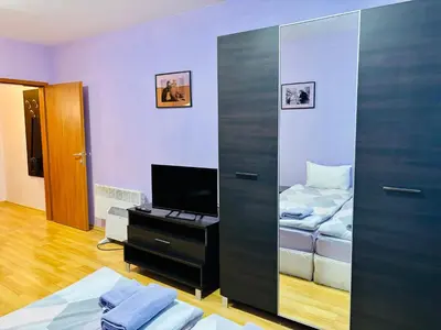 a bedroom with a mirror and a bed and a television at Predela 1 - Studio 10 near Bansko Ski Lift in Bansko