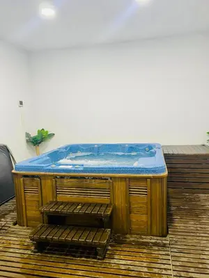 a hot tub sitting on top of a wooden deck at Predela 1 - Studio 10 near Bansko Ski Lift in Bansko
