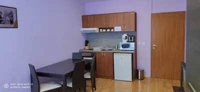 a small kitchen with a table and a microwave at Predela 1 - Studio 10 near Bansko Ski Lift in Bansko