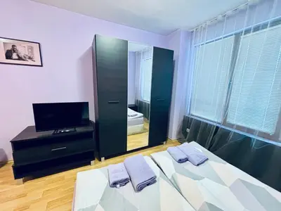 a bedroom with a bed with a mirror and a tv at Predela 1 - Studio 10 near Bansko Ski Lift in Bansko