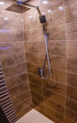a shower with a hose in a bathroom at Boutique 1-bedroom flat in the heart of the city in Plovdiv